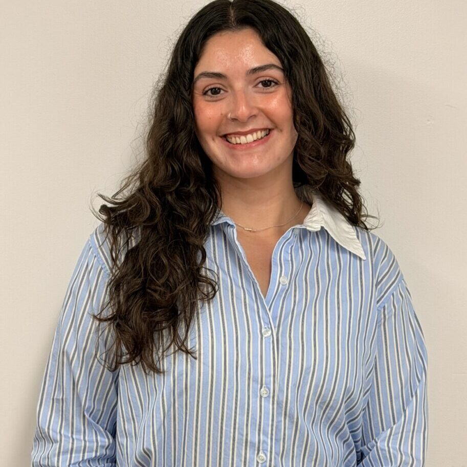 Smiling woman in blue striped button-up shirt