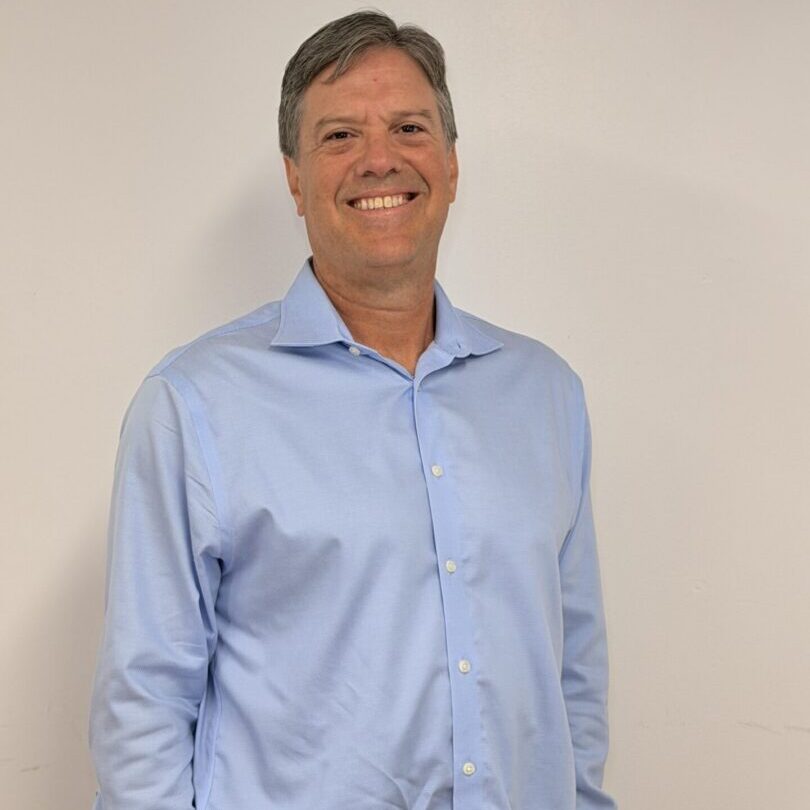 Smiling man wearing light blue dress shirt