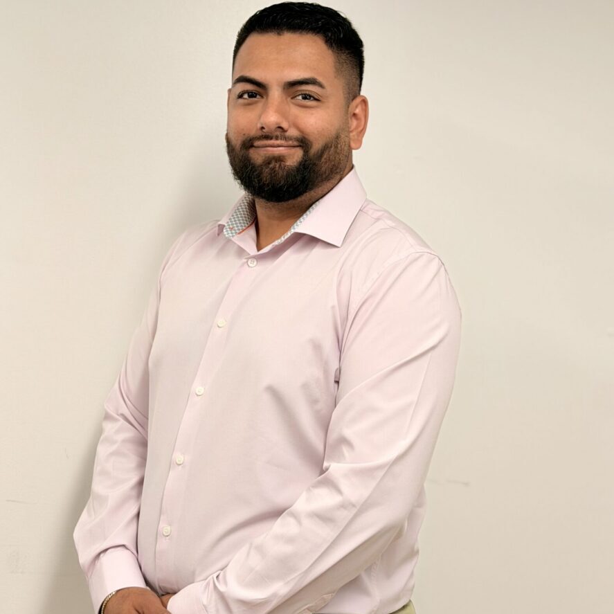 Smiling man in light pink shirt