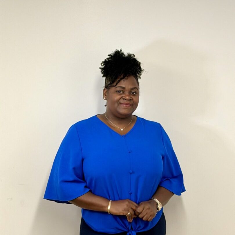 Smiling woman wearing bright blue blouse