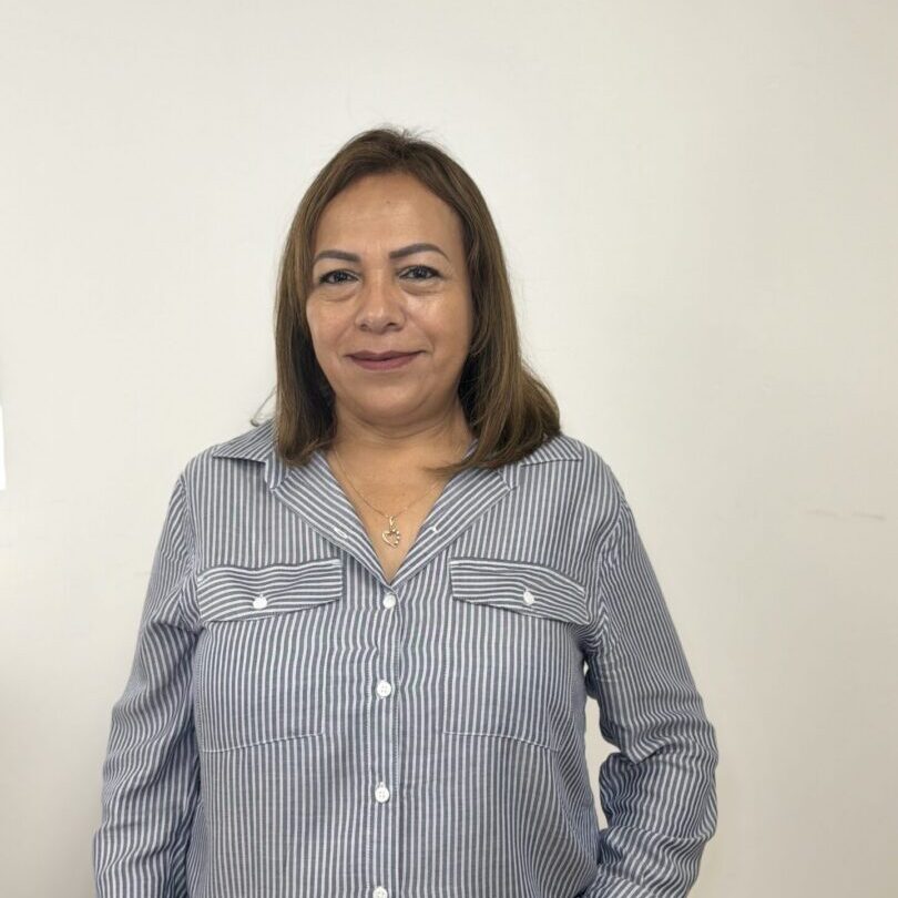 Woman smiling in striped button-up shirt